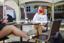 Young women hanging out at the Plaza near the Nebraska Union. Wearing masks on city campus. Septembe