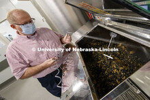 Dave Annis, Director of University Dining Service, sprays down the food and enzyme pellets in the bi
