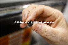 Dave Annis, Director of University Dining Service, holds one of the enzyme pellets which digests the