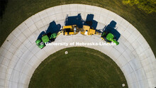 A tractor pulls the test car (yellow) and an additional tractor for weight as it rounds the test tra