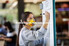 Madison Han, senior in Nutritional Science and Dietetics, uses a white marker board in the Adele Cor
