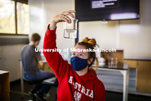 Raegan Hoyle, freshman from Fremont, Nebraska, checks her spinach leaf punches for her photosynthesi