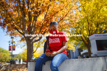 Brianna Rosalez, a freshman from Kansas City, enjoys the sunshine as she checks her phone during the