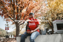 Brianna Rosalez, a freshman from Kansas City, enjoys the sunshine as she checks her phone during the