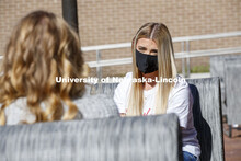 Students sit on the new patio along the south side of the Nebraska East Union. East Campus photo sho