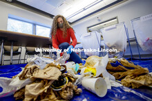 Morgan Hartman sorts waste in an Andersen Hall classroom. The waste audit was performed on trash sav