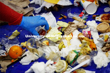 Morgan Hartman sorts through the trash. The waste audit was performed on trash saved by the custodia