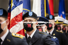 Joseph Carlin carries the US flag as part of the ROTC Color Guard. Volunteers read the names of near
