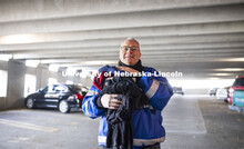 Kirk McManus with Parking and Transit Service holds clothing items he's collected for his monthly dr