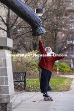 Khadieja Abuzaho, freshman from Lincoln, touches the foot of Archie the Mammoth in front of the Nebr