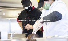 Professor Ajai Ammachathram oversees the carving of the prime rib as his Catering Management student
