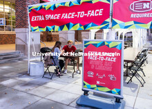 Students study outside of the Nebraska Union under the tents installed to help with social distancin