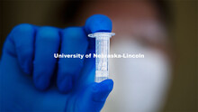 Stephanie Padilla, R.N. holds a completed test tube of the new saliva-based COVID test the students,