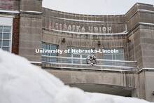 The Nebraska Union is ready for christmas with it's wreath and bricks covered in snow. Snow on UNL C