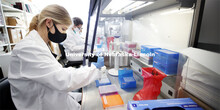 Lauren Weis transfers treated saliva samples to the PCR plate for the actual testing. Once the virus