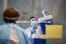 Coolers with samples are brought into the Saliva-based diagnostic testing program to the lab space i