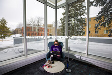 Lydia Cole, a senior from Plattsmouth, NE, studies in the corner seat ner the windows of the Dinsdal