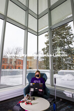 Lydia Cole, a senior from Plattsmouth, NE, studies in the corner seat ner the windows of the Dinsdal