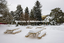 The picnic tables outside of the Nebraska East Union on East Campus are covered in more than 14” o