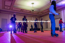 Students skate in a circle during the Club 80 Roller Skating Event in the Nebraska Union Ballroom on