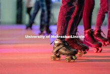 Students skate in a circle during the Club 80 Roller Skating Event in the Nebraska Union Ballroom on