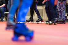 Students skate in a circle during the Club 80 Roller Skating Event in the Nebraska Union Ballroom on