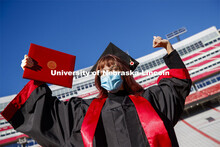 Macy Behrens, senior in advertising and public relations and also graphic design, poses in regalia t