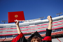 Macy Behrens, senior in advertising and public relations and also graphic design, poses in regalia t