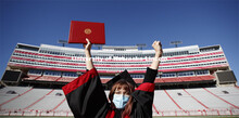 Macy Behrens, senior in advertising and public relations and also graphic design, poses in regalia t