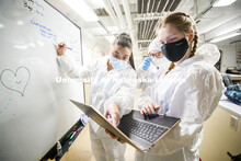 Symone Arends, Ryen Manning, and Alysa Ehlers look over their notes as the CSI team prepares to work