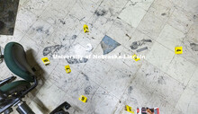Evidence markers and a ruler are placed next to footprints being collected as evidence. Forensic Sci
