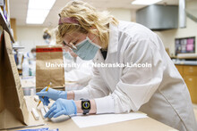 Tristan Kleinschrodt lays out her DNA evidence before entering the data on her logs. Forensic Scienc
