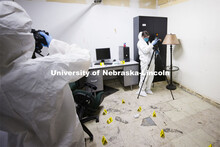 Evidence is photographed and collected as students work a mock crime scene. Forensic Science 485 is 