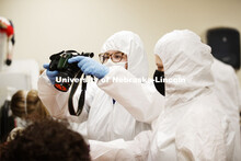 Ryen Manning photographs the victim. Forensic Science 485 is the capstone for the seniors. The CSI o