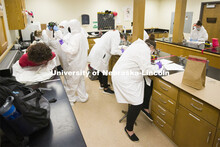 CSI students photograph the mock body while the lab group logs in the evidence bags. Forensic Scienc