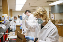 Tristan Kleinschrodt removes a sock which has a spot which appears to be blood and will be tested by