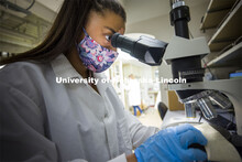 Symone Arends uses a microscope to examine a piece of evidence. Forensic Science 485 is the capstone