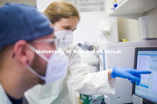 Rebecca Roston, associate professor in biochemistry, looks over the data from a fatty acid with Zach