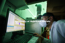 Zach Shomo looks over the data from a fatty acid. He is looking at the read-out of a detector after 