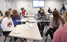 LeAnn Bugay discusses a topic with the group in UHON 102H: The Science of You. Students interact wit