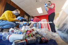 Students check the recycle labels on bottles from Hardin Hall. Environmental Studies Orientation stu