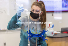 Teagan Gaul adds silica to a burette. The Chemistry 106 lab experiment will filter chlorophyll from 