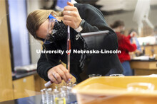 Danielle Kasselder, a freshman from Calhan, CO, measures the dye in her pipette. Students perform sp