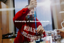 Rachel Clarkson, a freshman from Gilbert, Arizona, measures the dye in her pipette. Students perform