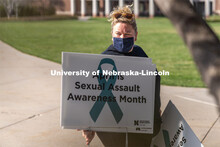 CARE Advocate Melissa Wilkerson organizes signs before placing them at the Nebraska Union Greenspace