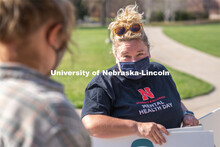 CARE Advocate Melissa Wilkerson speaks to volunteers before setting up their display at the Nebraska