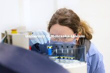 Michelle Takacs practices loading samples into the auto sampler on the high-field NMR (nuclear magne