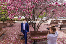 Lucas Zelnio has his photo taken by Avery Bowman under the Saucer Magnolia trees blooming outside of