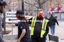 Chancellor Ronnie Green directs people to the vaccine clinic entrance Friday afternoon. Green and Ja