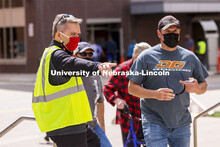 Chancellor Ronnie Green directs people to the vaccine clinic entrance Friday afternoon. Green and Ja